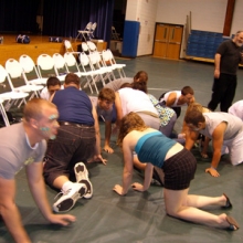 People crawling on stage hypnotized